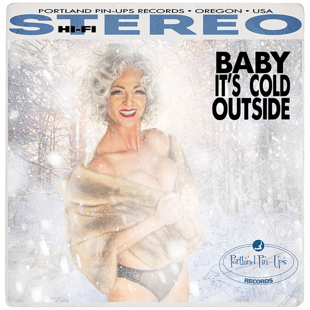 Smiling woman with short gray hair, posing in lingerie and fur stole in snowy forest. Text reads "Baby It’s Cold Outside." Vintage album cover style.