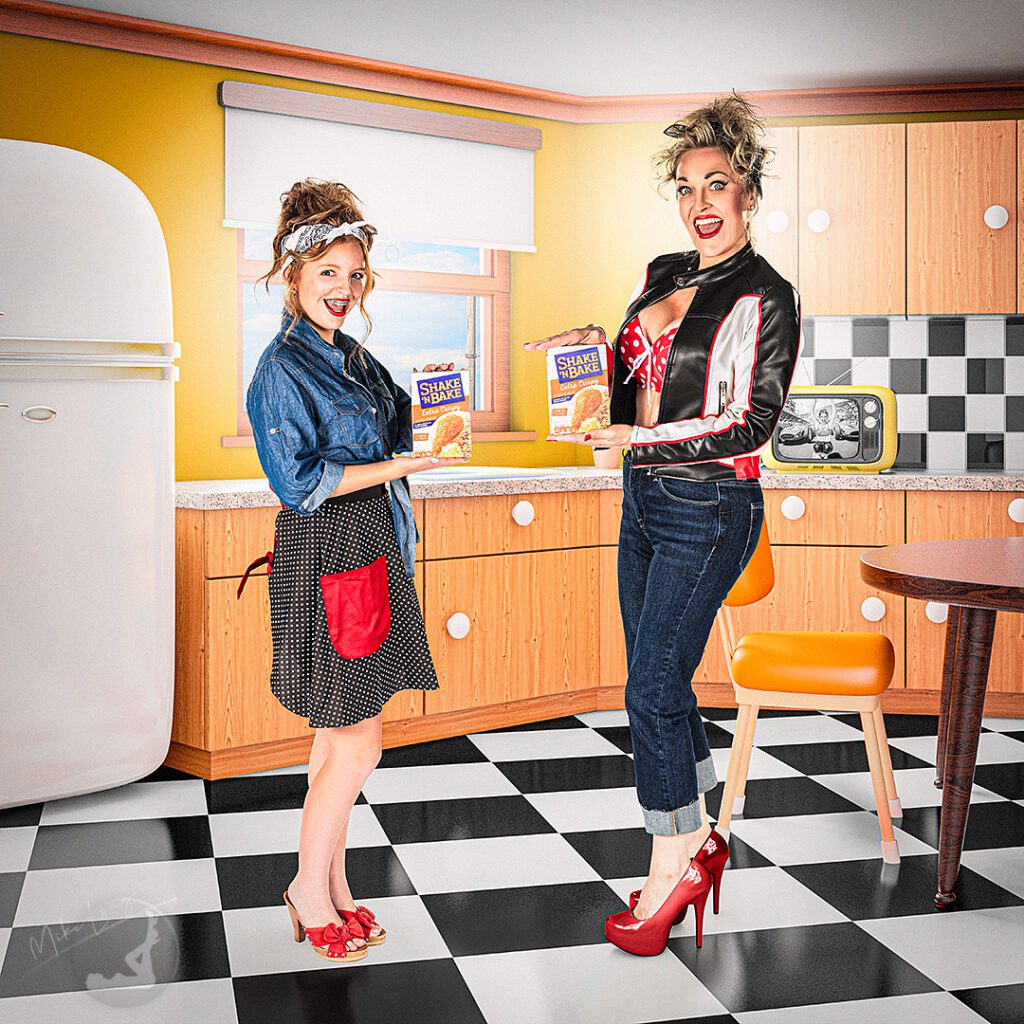 Mother and daughter in a 1950s kitchen holding a vintage Shake 'N Bake box, playful retro portrait